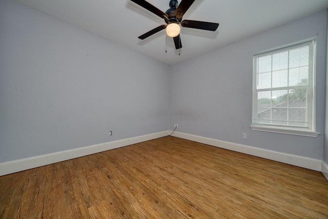 empty room with ceiling fan and light hardwood / wood-style flooring