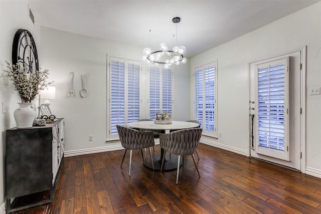 dining space featuring a notable chandelier, baseboards, and hardwood / wood-style floors