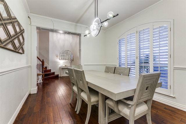 dining space featuring hardwood / wood-style flooring, stairway, a chandelier, and crown molding