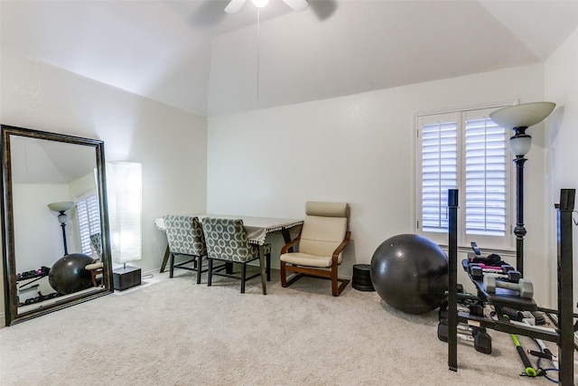 exercise area featuring lofted ceiling, a ceiling fan, and carpet flooring