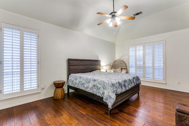 bedroom featuring visible vents, vaulted ceiling, hardwood / wood-style floors, and multiple windows