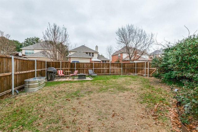 view of yard with an outdoor fire pit, a patio area, and a fenced backyard