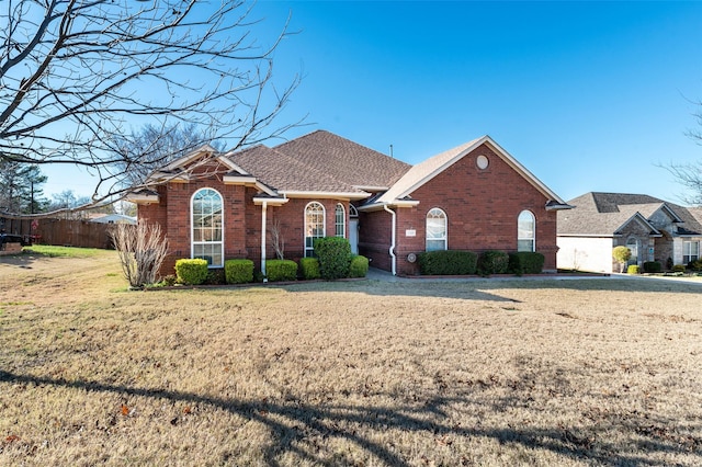 ranch-style home featuring a front yard