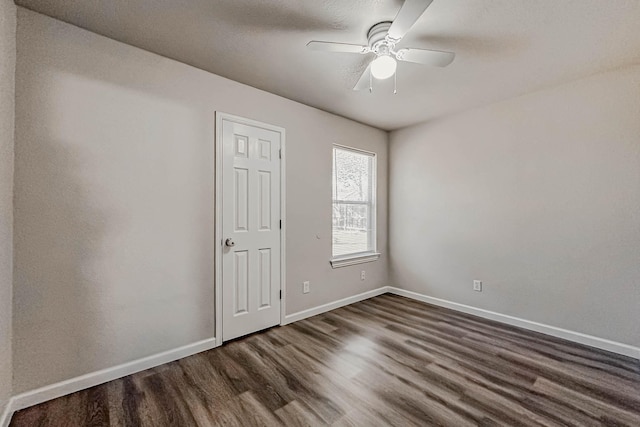 spare room with a textured ceiling, dark hardwood / wood-style floors, and ceiling fan