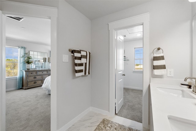 bathroom featuring plenty of natural light and sink