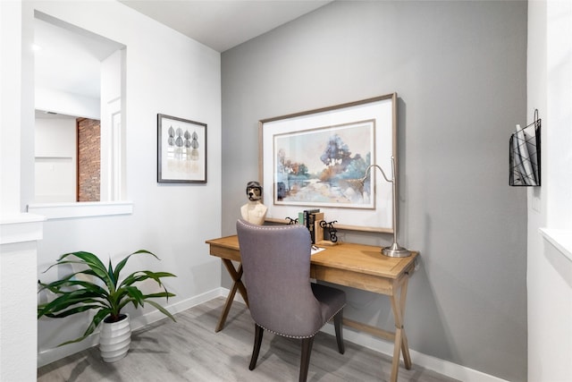 office area with light hardwood / wood-style floors