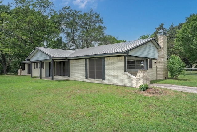 view of front facade with a patio and a front lawn