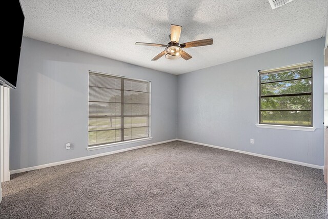 carpeted empty room with a textured ceiling and ceiling fan