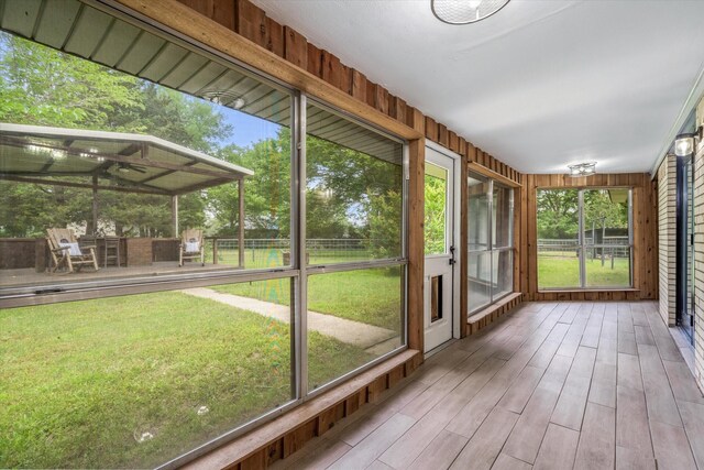 unfurnished sunroom featuring a healthy amount of sunlight