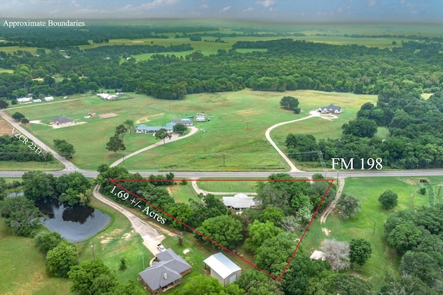 birds eye view of property with a water view and a rural view