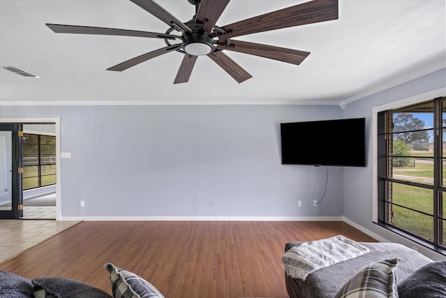 living room with wood-type flooring, ornamental molding, and ceiling fan