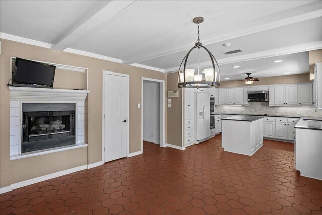 kitchen featuring stainless steel appliances, ceiling fan, sink, decorative light fixtures, and white cabinets