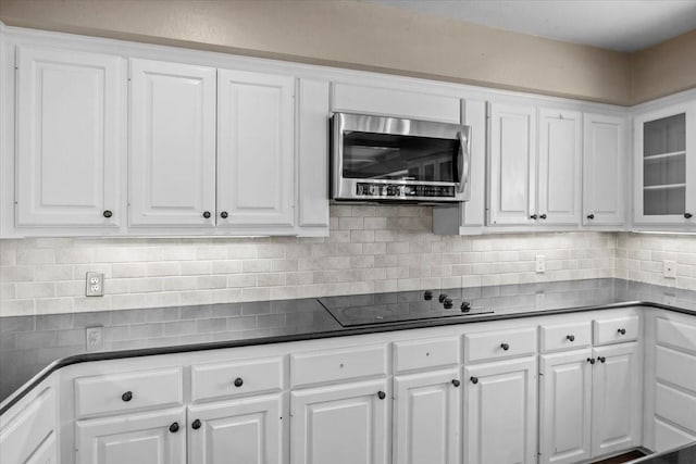 kitchen with white cabinets, tasteful backsplash, and black electric cooktop