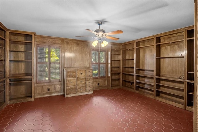 interior space with built in shelves, ceiling fan, and a wealth of natural light