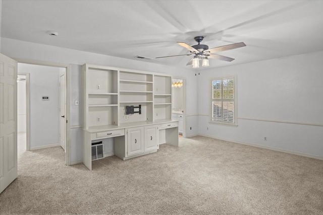 unfurnished office featuring ceiling fan and light colored carpet