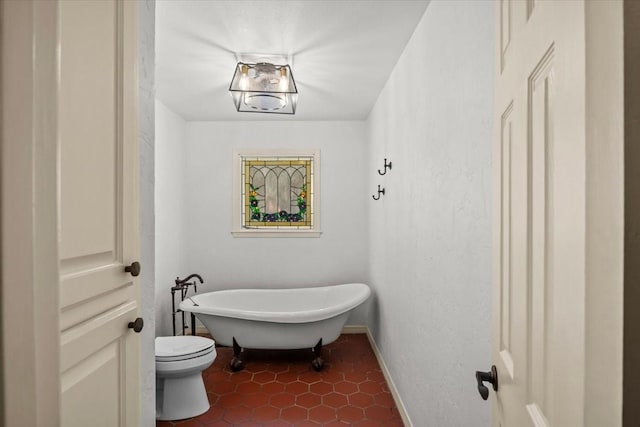 bathroom featuring a bath and toilet