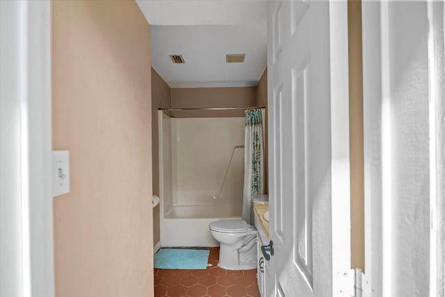 bathroom featuring tile patterned floors, toilet, and shower / bath combo with shower curtain