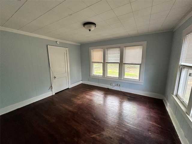 unfurnished room with dark hardwood / wood-style flooring, plenty of natural light, and ornamental molding