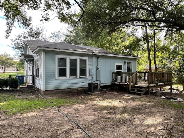 rear view of house featuring a deck and central AC