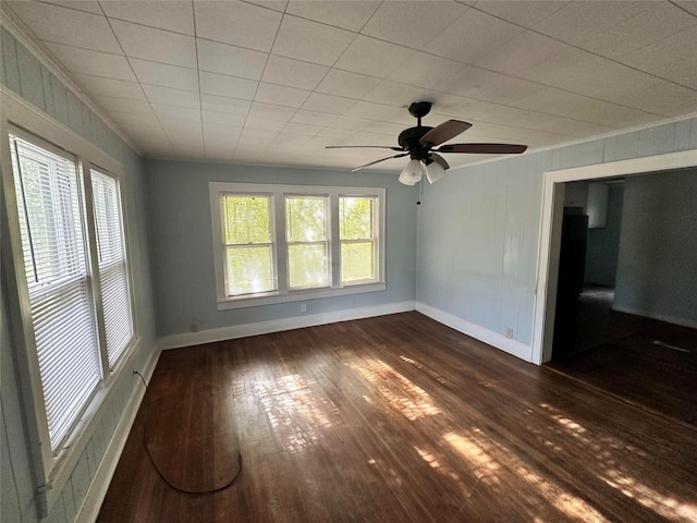 unfurnished room with dark hardwood / wood-style floors and ceiling fan