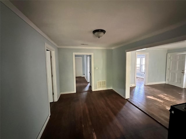 hallway featuring dark hardwood / wood-style floors and ornamental molding