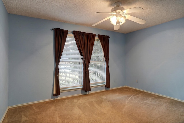 carpeted spare room featuring a textured ceiling and ceiling fan