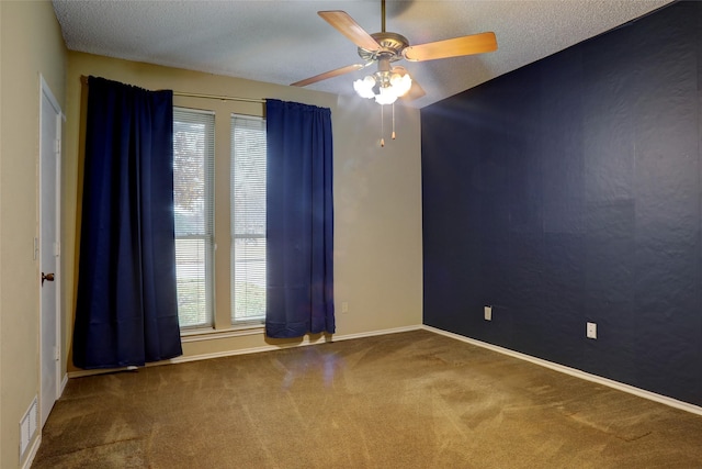 carpeted empty room featuring a textured ceiling and ceiling fan