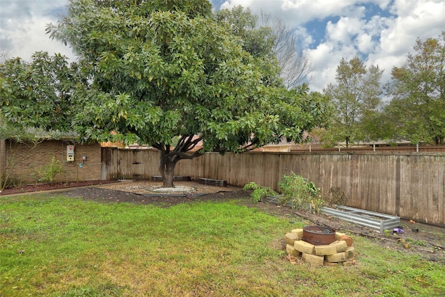 view of yard with an outdoor fire pit