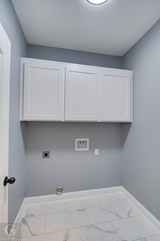 clothes washing area with hookup for a washing machine, electric dryer hookup, and cabinets