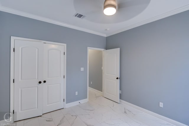 unfurnished bedroom with ceiling fan, a closet, and ornamental molding