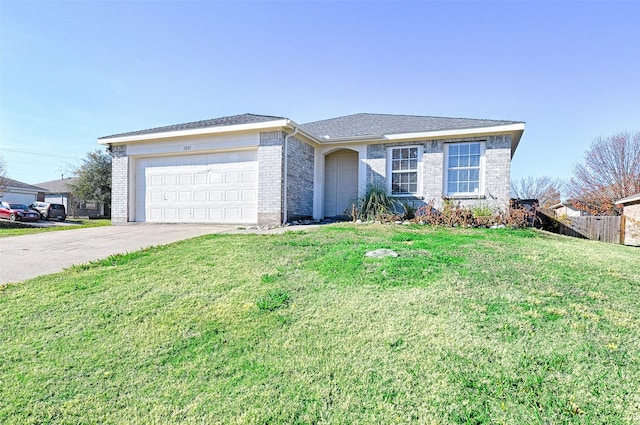 ranch-style house featuring a garage and a front lawn