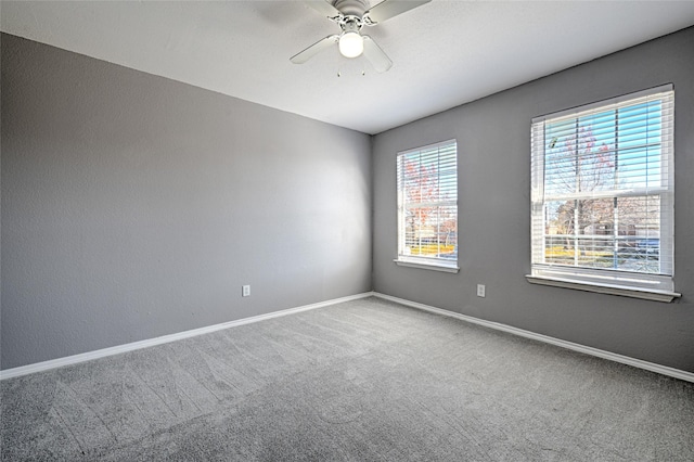 carpeted empty room with ceiling fan