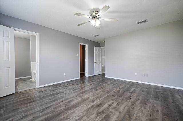 unfurnished bedroom with dark hardwood / wood-style flooring, connected bathroom, and ceiling fan