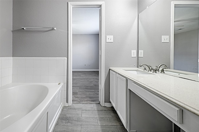 bathroom with vanity and a bath