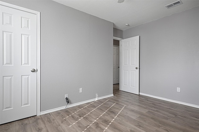 unfurnished bedroom with wood-type flooring