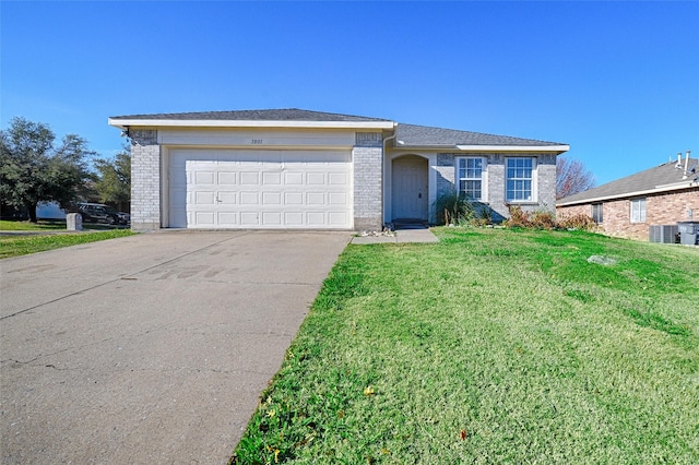 ranch-style house featuring a garage and a front lawn