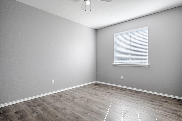 unfurnished room with ceiling fan and light wood-type flooring