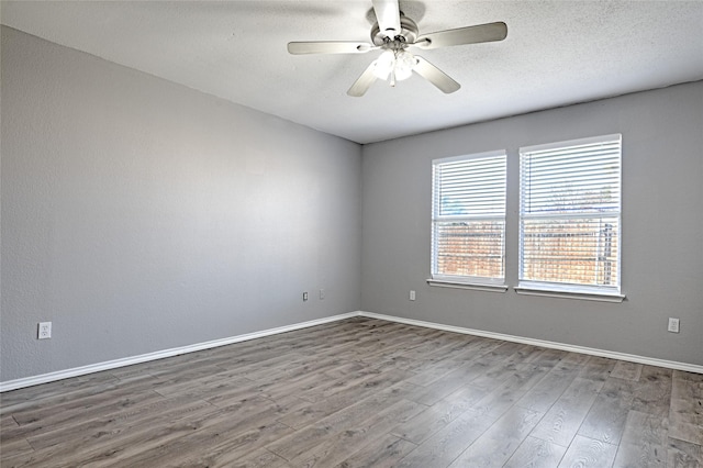 empty room featuring hardwood / wood-style flooring, ceiling fan, and a textured ceiling