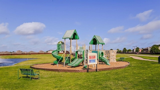 view of playground with a yard and a water view