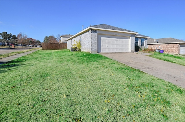 view of side of property with a garage and a lawn