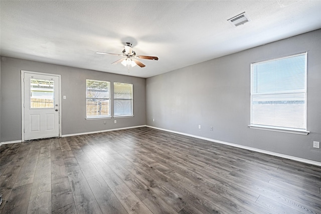 interior space featuring ceiling fan, a textured ceiling, and dark hardwood / wood-style flooring