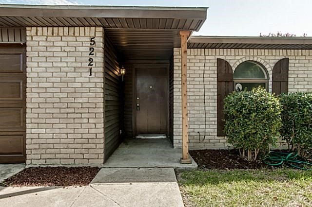 view of exterior entry with a garage