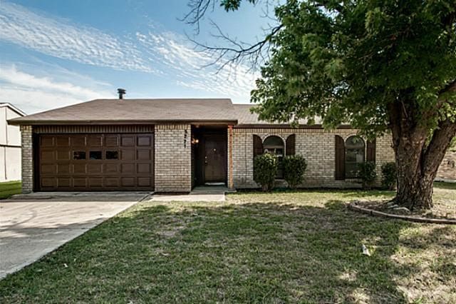 ranch-style home with a garage and a front lawn