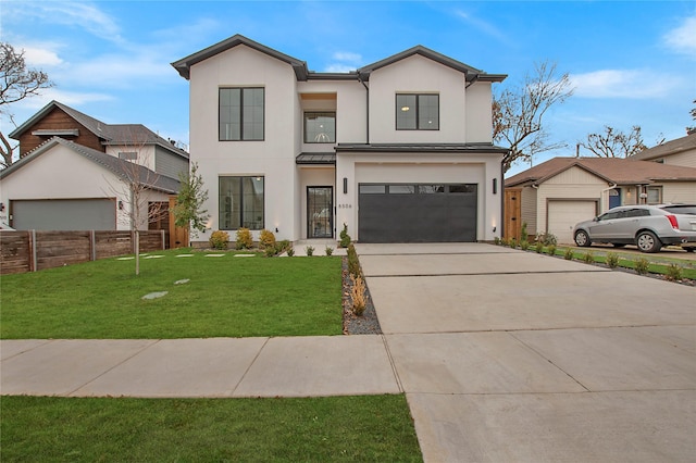 view of front of property with a front yard and a garage