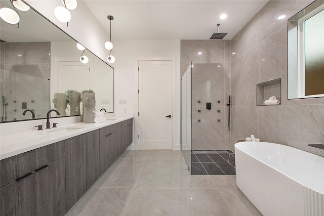 bathroom featuring vanity, separate shower and tub, and tile walls