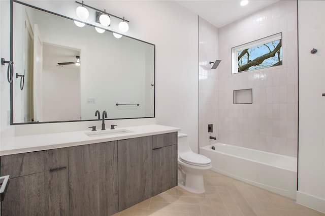 full bathroom featuring tile patterned floors, tiled shower / bath combo, toilet, and vanity