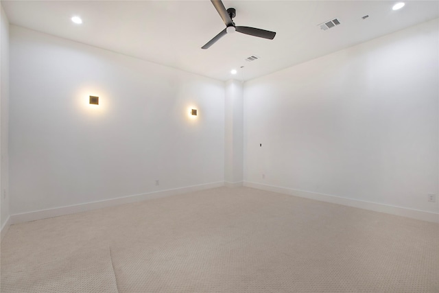 unfurnished room with light colored carpet and ceiling fan