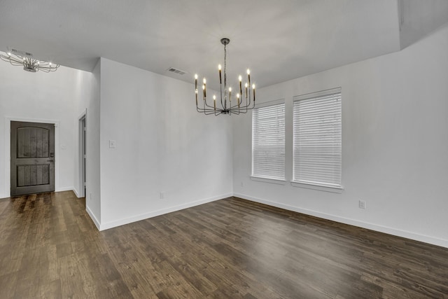 unfurnished dining area with a notable chandelier and dark hardwood / wood-style flooring