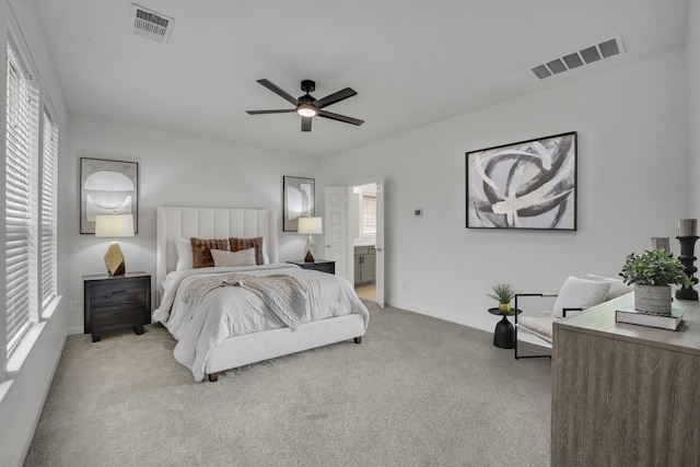 carpeted bedroom featuring ceiling fan and ensuite bathroom