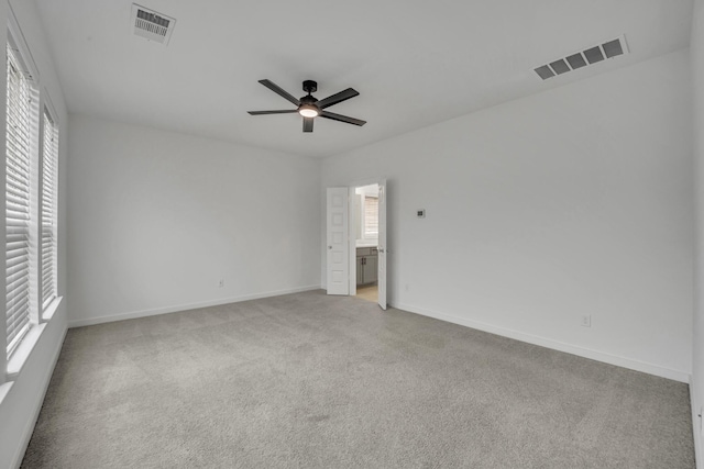 unfurnished room with light carpet, ceiling fan, and a healthy amount of sunlight